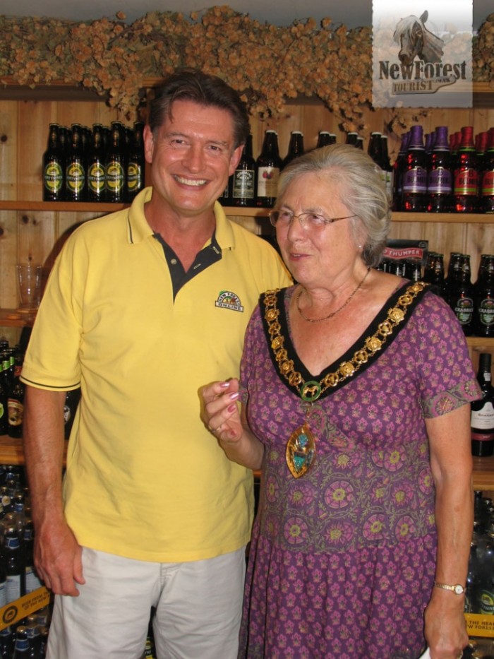 Mark Allen with Councillor Christine Ford as she strikes a pint-holding pose.